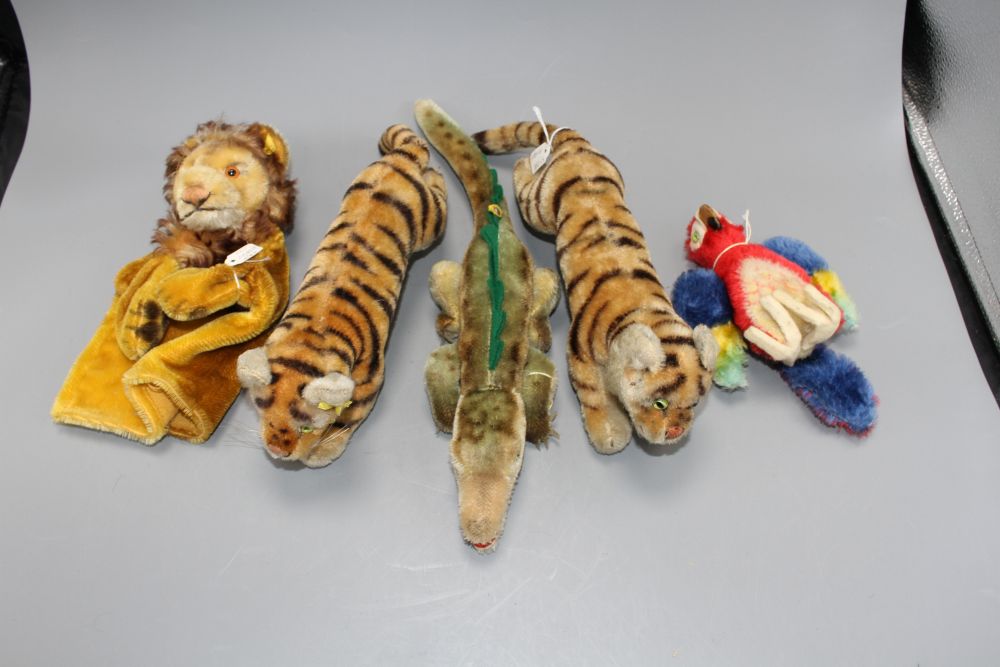 Two 1950s Steiff tigers, a crocodile, a parrot and a lion glove puppet